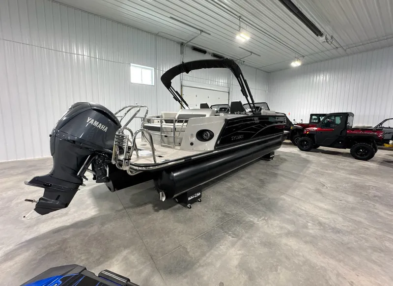 Slide: The Image of 2024 Sylvan G3 CLZ DC boat with Yamaha motor in a spacious indoor showroom. - 2