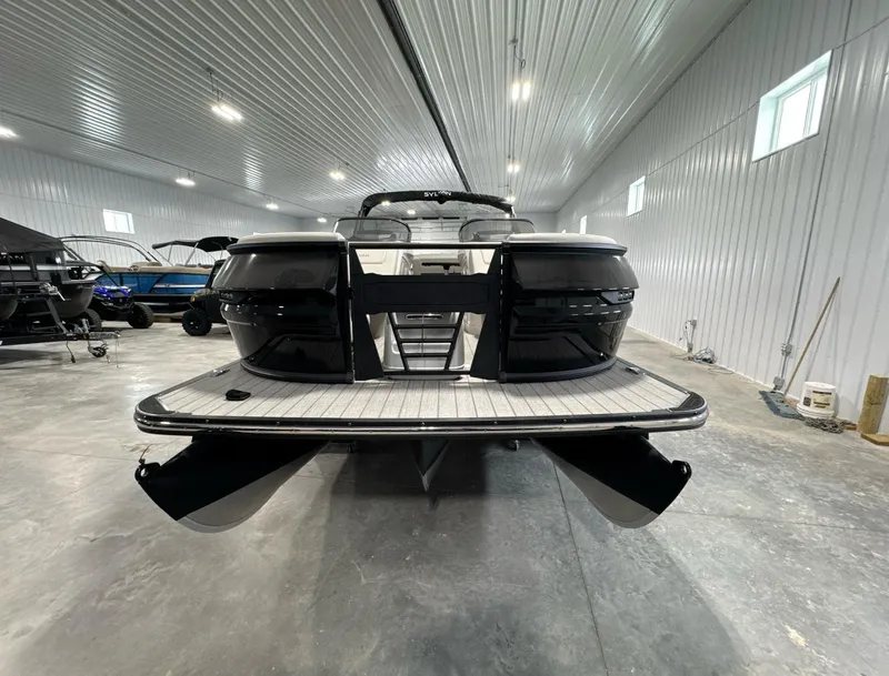 Slide: The Image of 2024 Sylvan G3 CLZ DC boat in a spacious indoor showroom. - 3