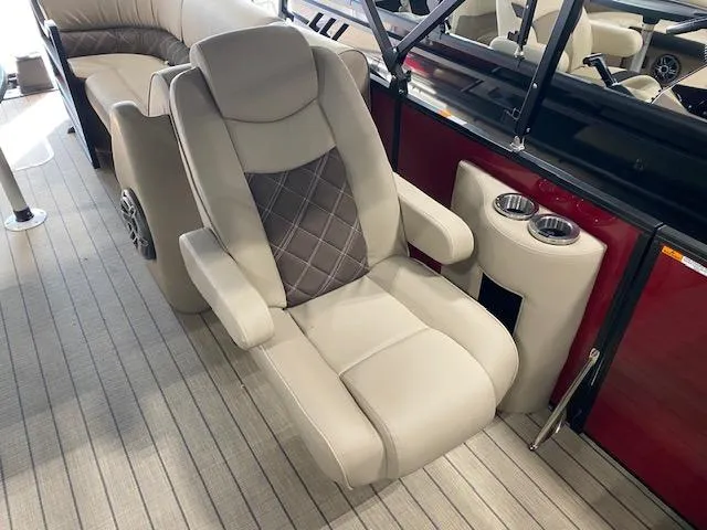 Slide: The Image of Luxurious seating on 2025 SunCatcher Elite 324 RC boat, featuring plush upholstery and cup holders. - 8