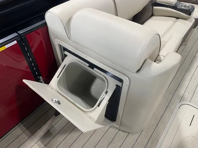 Slide: The Image of 2025 SunCatcher Elite 324 RC boat seat with built-in storage compartment open. - 9