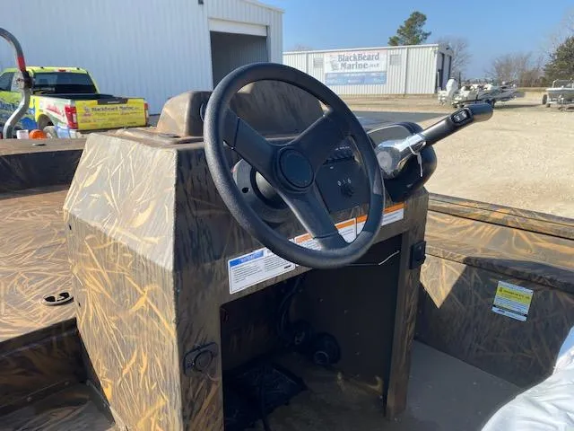 Slide: The Image of 2025 G3 Gator Tough 18 CCJ boat console with steering wheel and controls. - 3