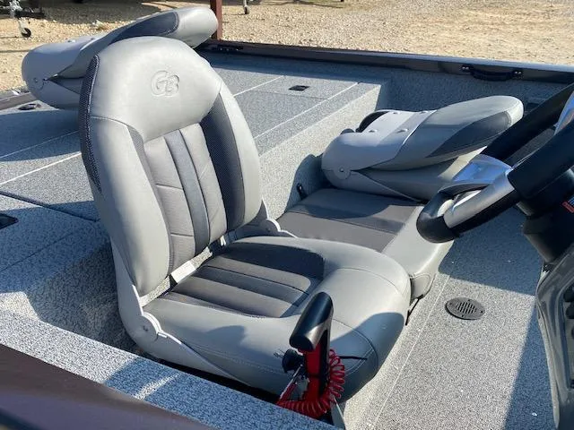 Slide: The Image of 2025 G3 Sportsman 1610 boat interior with gray seating and steering console. - 4