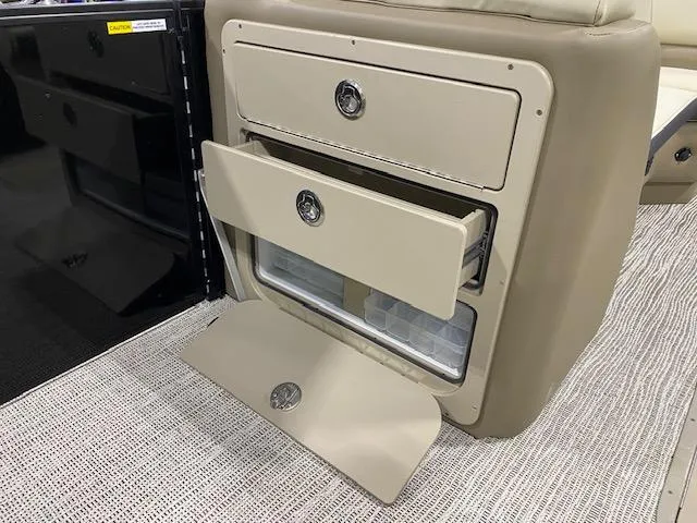 Slide: The Image of 2025 SunCatcher Select 322RF storage compartment with open drawers on a boat. - 11
