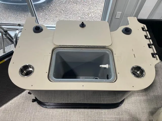 Slide: The Image of SunCatcher Select 322RF 2025 boat console with built-in cooler and cup holders. - 12