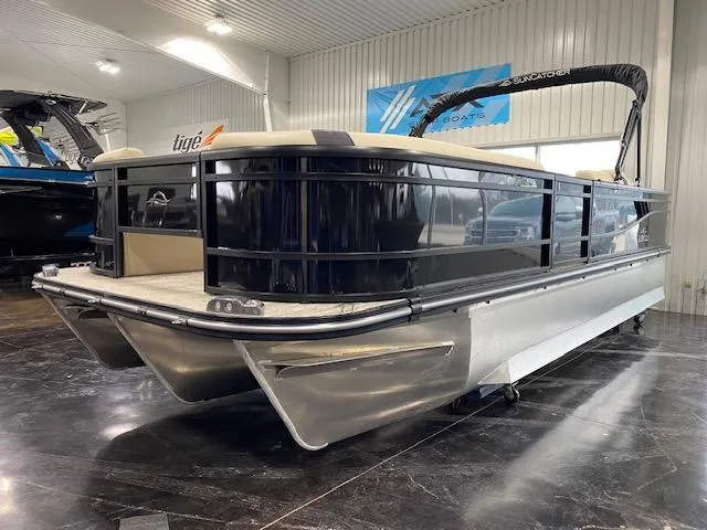 Slide: The Image of 2025 SunCatcher Select 322RF pontoon boat in showroom, featuring sleek design and modern amenities. - 3