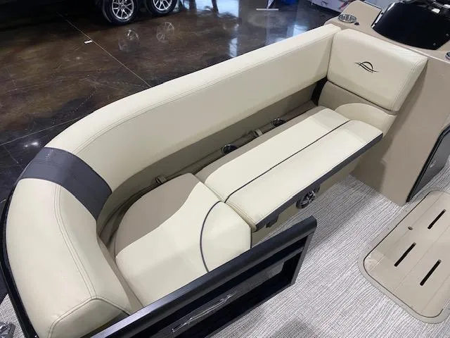Slide: The Image of 2025 SunCatcher Select 322RF boat interior with beige seating and modern design. - 6