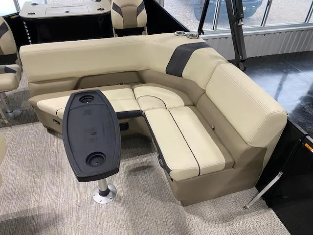 Slide: The Image of Luxurious seating area in 2025 SunCatcher Select 322RF boat with beige upholstery and table. - 7