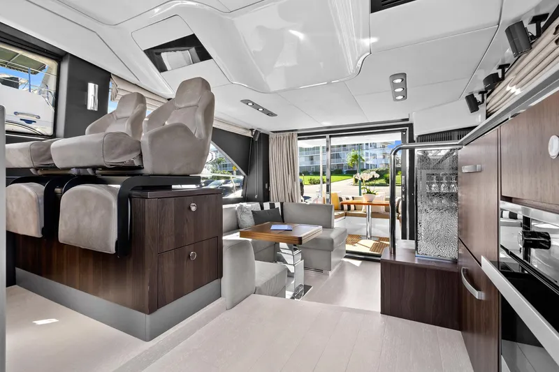 Slide: The Image of Luxurious interior of 2019 Azimut 50 Flybridge yacht with modern seating and dining area. - 10