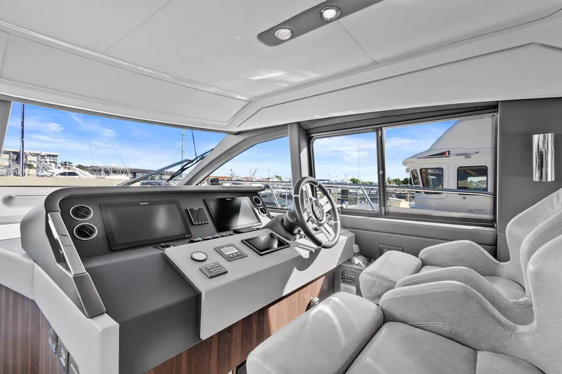 Slide: The Image of Luxurious interior of 2019 Azimut 50 Flybridge yacht with modern helm and plush seating. - 11