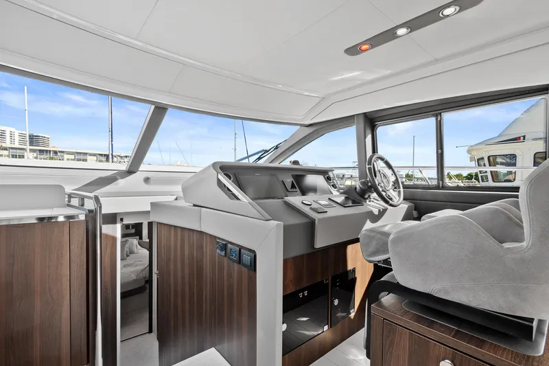 Slide: The Image of 2019 Azimut 50 Flybridge yacht interior with modern helm and panoramic windows. - 13