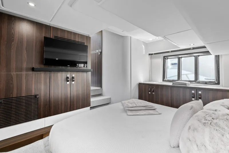 Slide: The Image of Luxurious interior of 2019 Azimut 50 Flybridge yacht with modern furnishings and TV. - 16