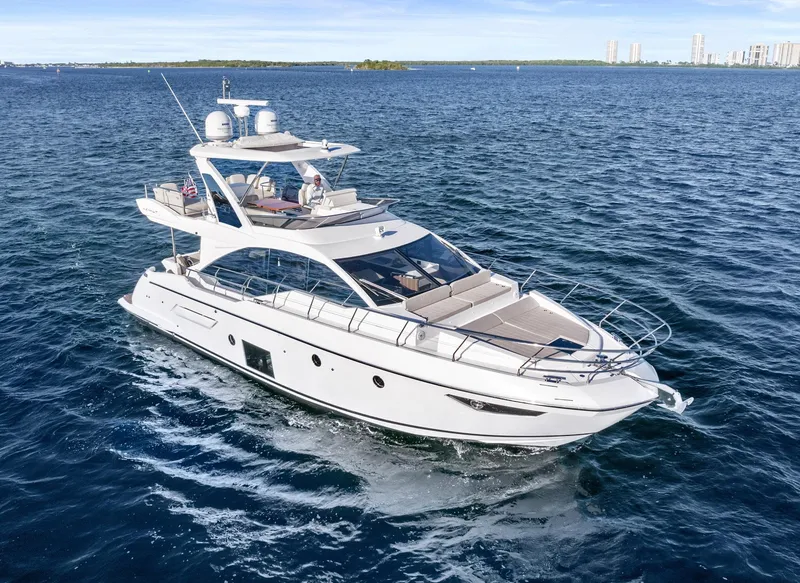 Slide: The Image of 2019 Azimut 50 Flybridge yacht cruising on open water. - 29