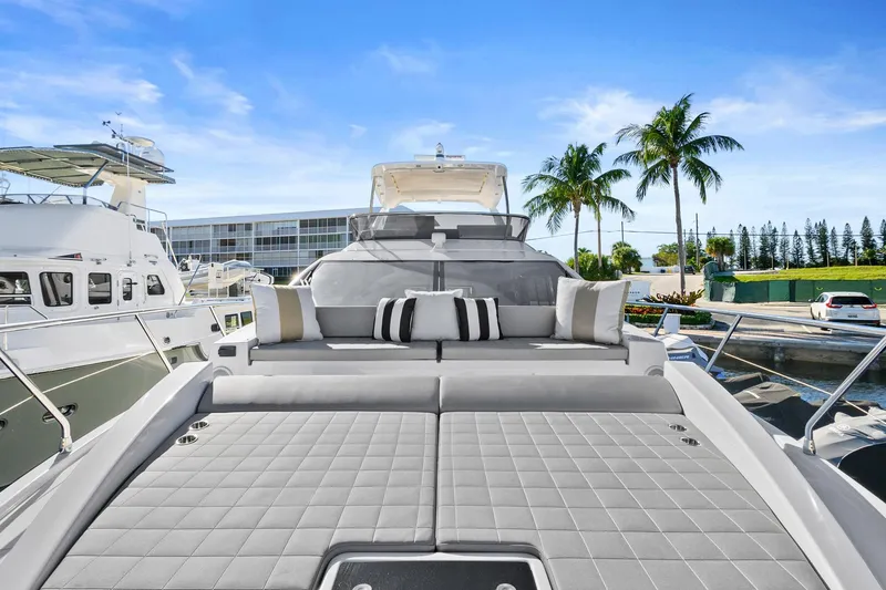 Slide: The Image of Luxurious 2019 Azimut 50 Flybridge yacht with sunbathing area, docked in a tropical marina. - 30