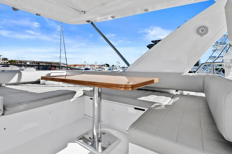 Slide: The Image of Azimut 50 Flybridge 2019 yacht interior with seating and table, featuring marina view. - 35