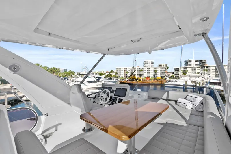 Slide: The Image of Azimut 50 Flybridge 2019 yacht interior with helm, seating, and marina view. - 36