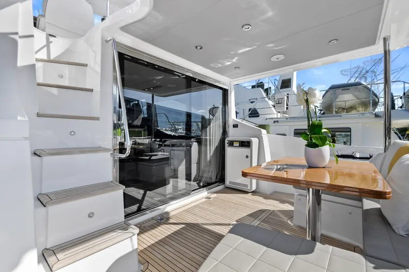 Slide: The Image of Azimut 50 Flybridge 2019 yacht interior with modern seating and table setup. - 41