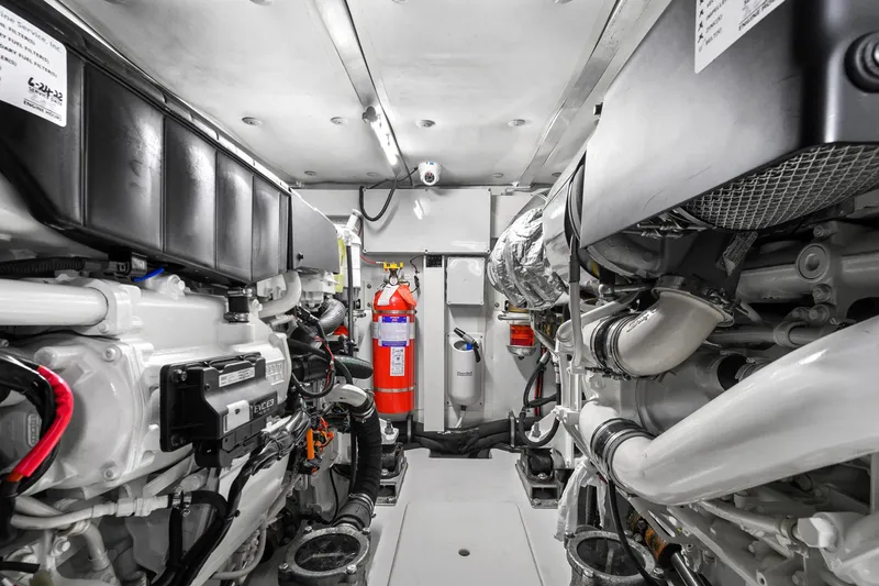 Slide: The Image of Engine room of 2019 Azimut 50 Flybridge yacht, featuring modern equipment and fire extinguisher. - 45