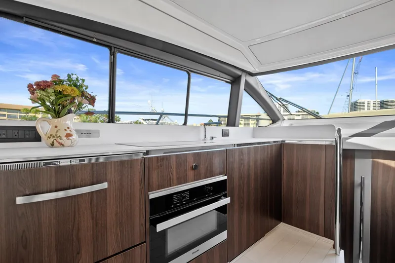 Slide: The Image of Luxurious kitchen interior of 2019 Azimut 50 Flybridge yacht with modern wood cabinetry. - 9