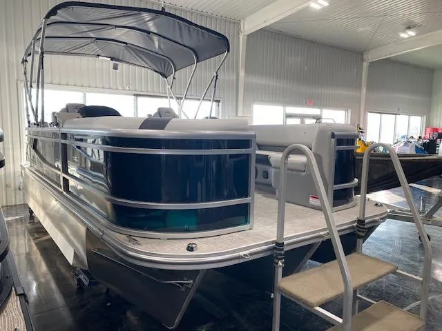 Slide: The Image of 2025 SunCatcher Select 320 RC pontoon boat in showroom, featuring sleek design and canopy. - 0