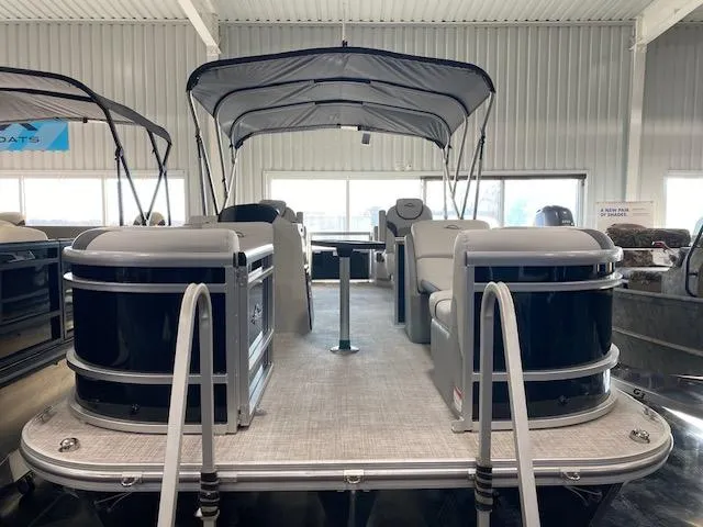 Slide: The Image of 2025 SunCatcher Select 320 RC pontoon boat in showroom, featuring spacious seating and canopy. - 1