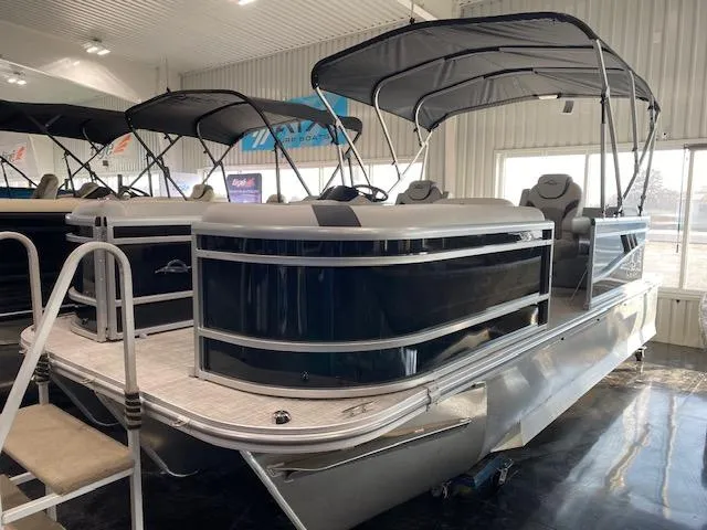 Slide: The Image of 2025 SunCatcher Select 320 RC pontoon boat in showroom, featuring sleek design and canopy. - 2