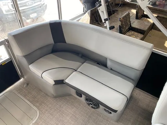 Slide: The Image of 2025 SunCatcher Select 320 RC boat interior with gray seating and speaker system. - 9