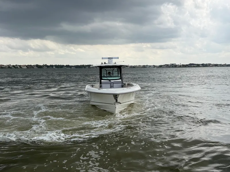 Slide: The Image of Boston Whaler 360 Outrage 2026 on choppy waters under cloudy skies. - 3