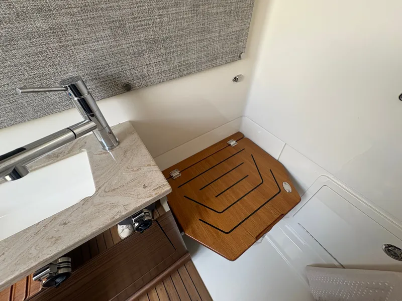 Slide: The Image of Interior of 2026 Boston Whaler 360 Outrage with sink and wood accents. - 40