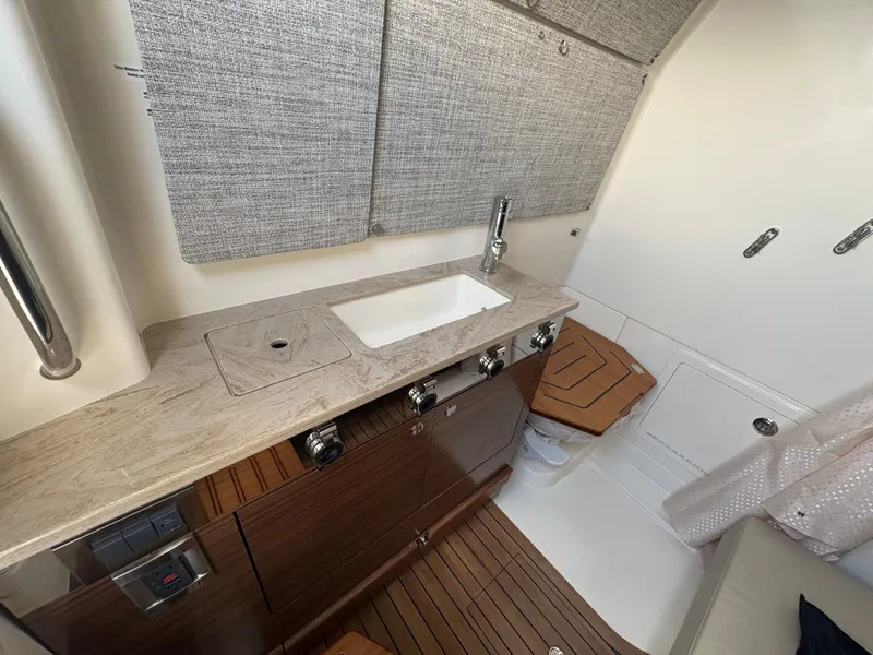 Slide: The Image of Interior of 2026 Boston Whaler 360 Outrage with sink and wood paneling. - 42