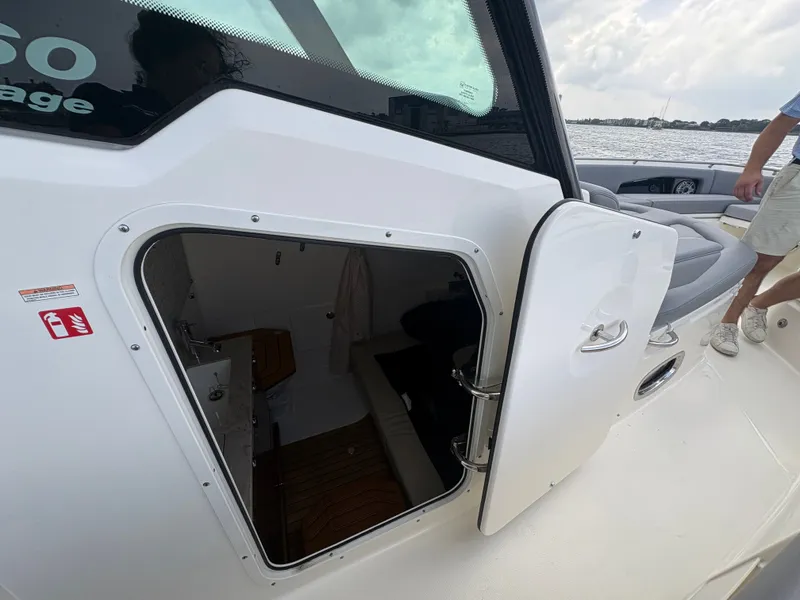 Slide: The Image of 2026 Boston Whaler 360 Outrage with open cabin door. - 45