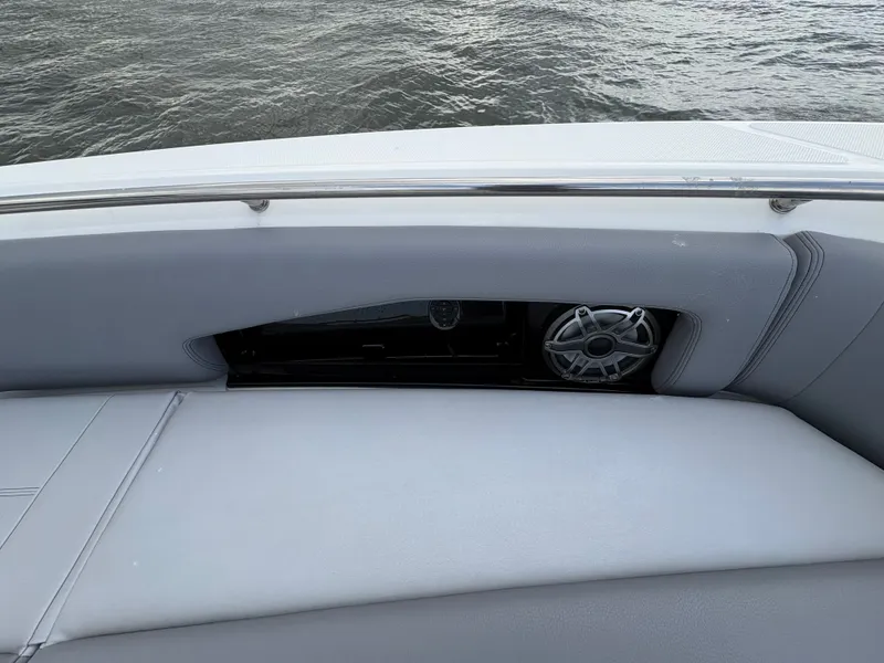 Slide: The Image of Boston Whaler 360 Outrage 2026, seating area with speaker by the water. - 46