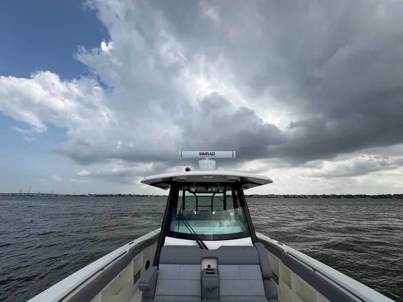 Slide: The Image of Boston Whaler 360 Outrage 2026 on choppy sea under dramatic sky. - 49