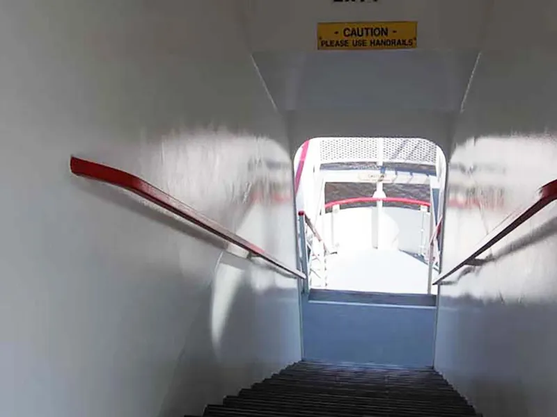 Slide: The Image of Staircase on 1985 Custom Serodino Dinner Boat with caution sign and handrails. - 11