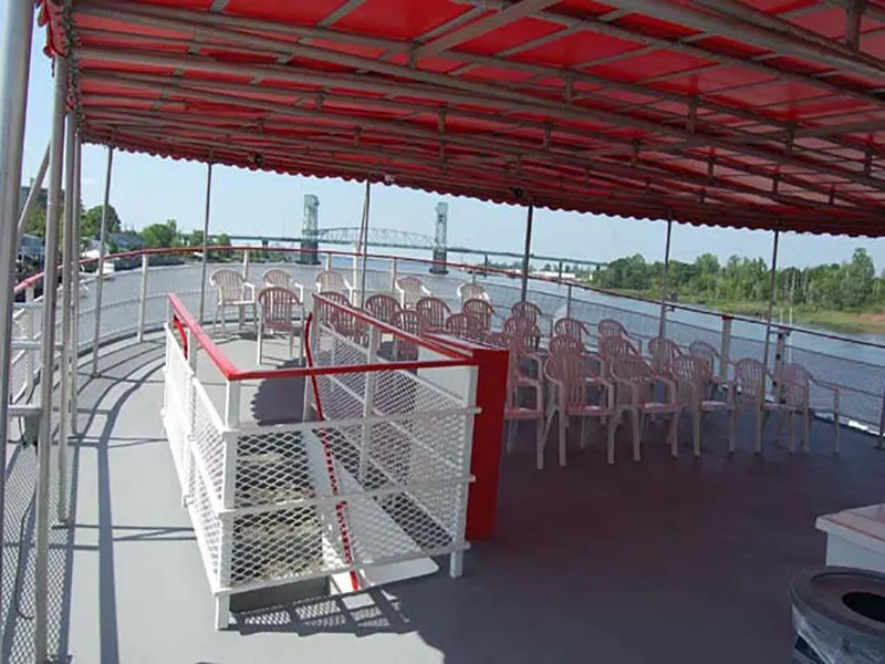 Slide: The Image of Upper deck of 1985 Custom Serodino Dinner Boat with red canopy and white chairs. - 12