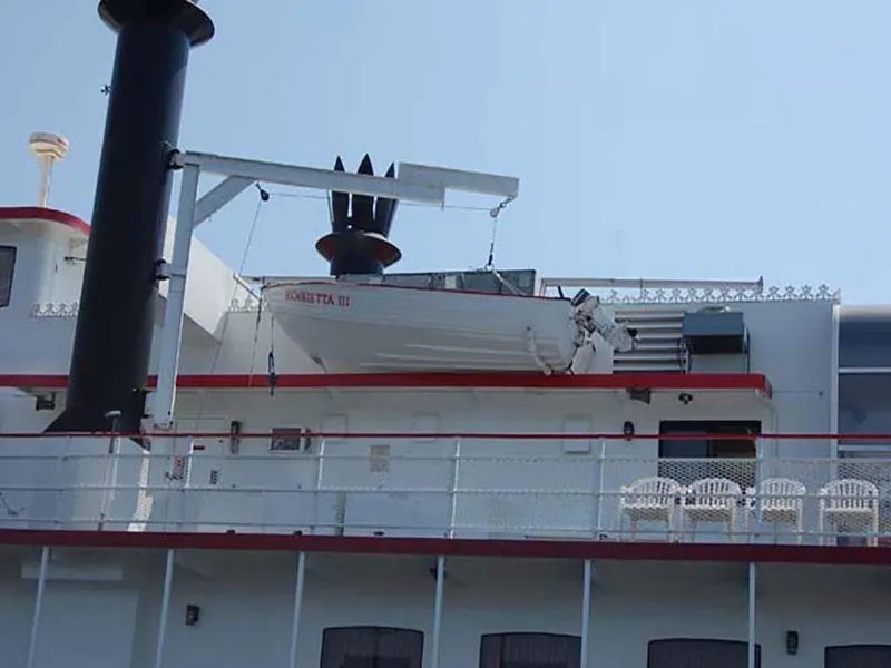 Slide: The Image of Custom 1985 Serodino Dinner Boat with lifeboat on deck, featuring classic design elements. - 4