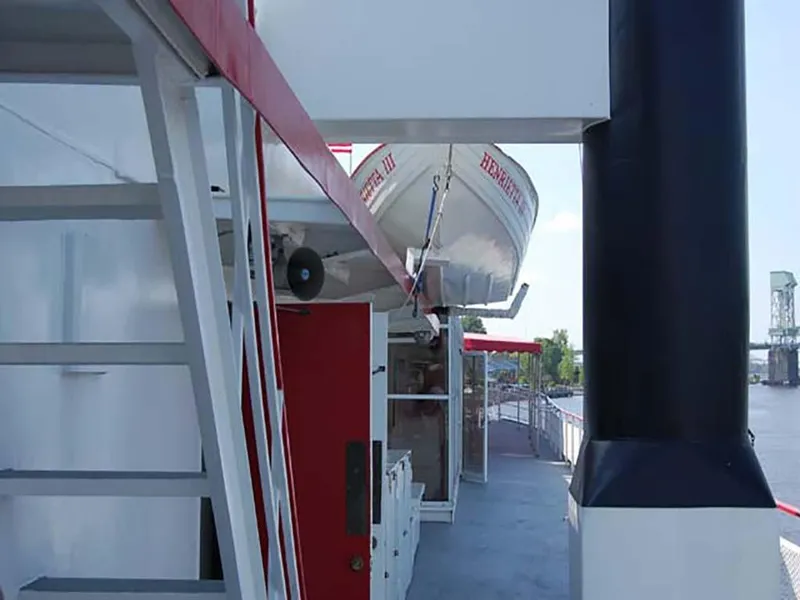 Slide: The Image of Custom 1985 Serodino Dinner Boat with lifeboat on deck, river view in background. - 7