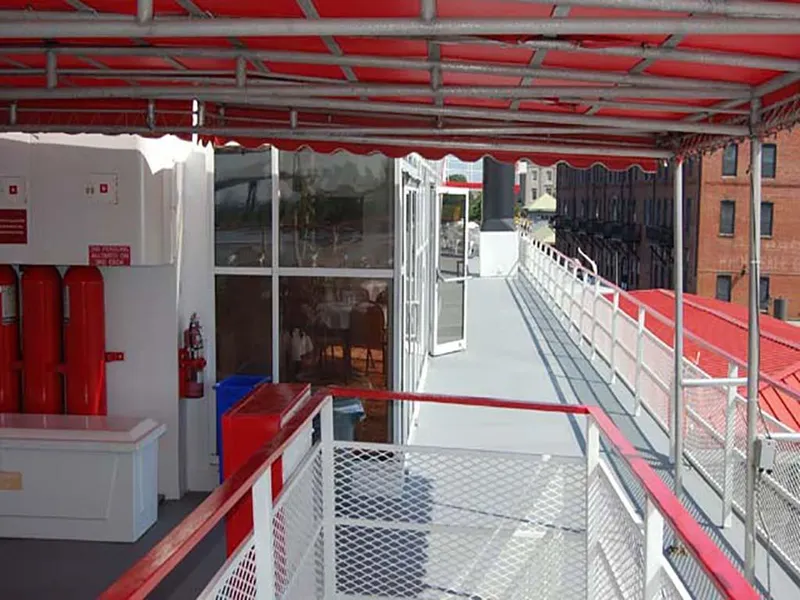 Slide: The Image of Upper deck of 1985 Custom Serodino Dinner Boat with red canopy and safety equipment. - 8