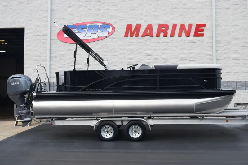 Slide: The Image of 2025 Bennington 21 SL pontoon boat on trailer at marine dealership. - 1