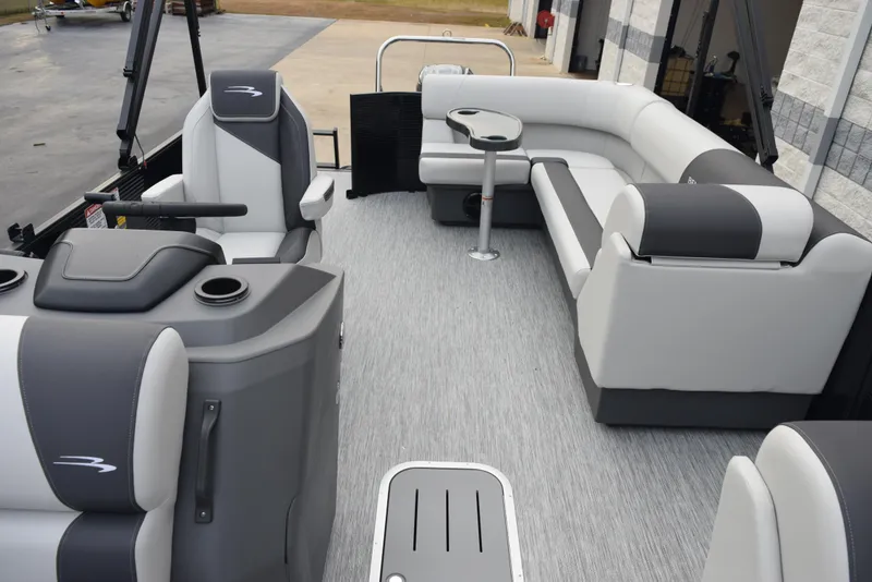 Slide: The Image of 2025 Bennington 21 SL pontoon boat interior with gray and white seating and modern design. - 12