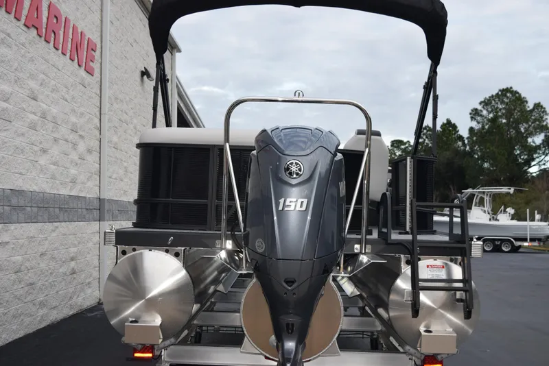 Slide: The Image of 2025 Bennington 21 SL pontoon boat with Yamaha 150 outboard motor, docked outdoors. - 5
