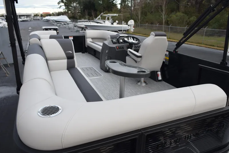Slide: The Image of 2025 Bennington 21 SL pontoon boat interior with plush seating and modern helm. - 7