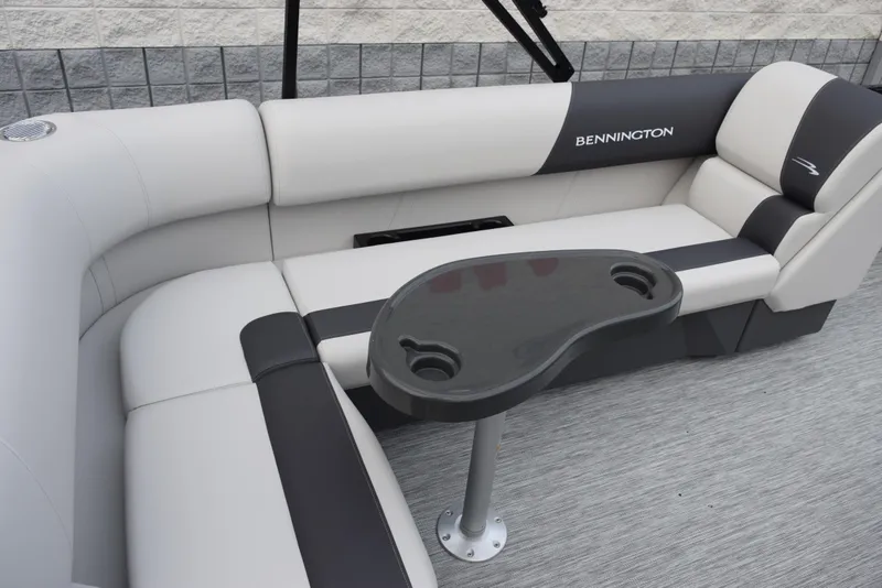 Slide: The Image of 2025 Bennington 21 SL pontoon boat interior with cushioned seating and a central table. - 8