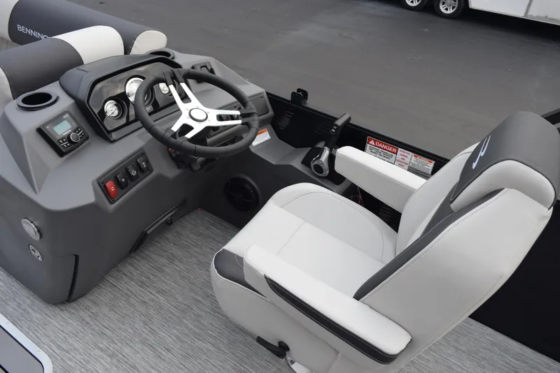 Slide: The Image of 2025 Bennington 21 SL boat interior with steering wheel and captain's chair. - 9