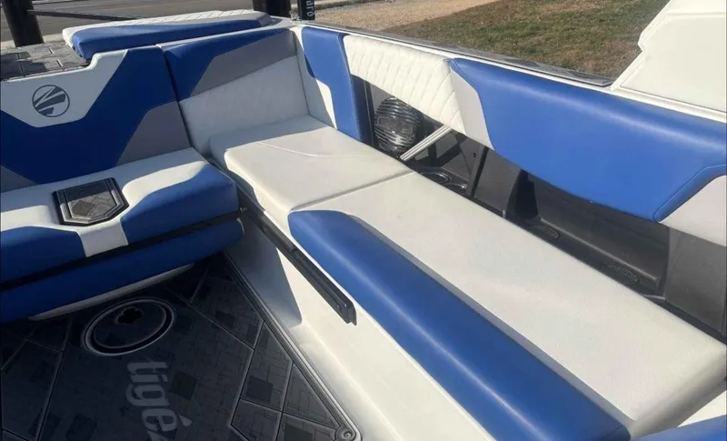 Slide: The Image of 2024 Tigé Z5 boat interior with blue and white seating, modern design. - 10