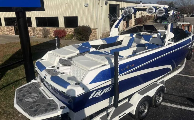Slide: The Image of 2024 Tigé Z5 boat with blue and white design on a trailer. - 2