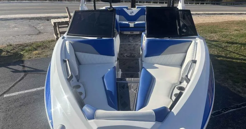 Slide: The Image of 2024 Tigé Z5 boat with blue and white interior, parked on pavement. - 5