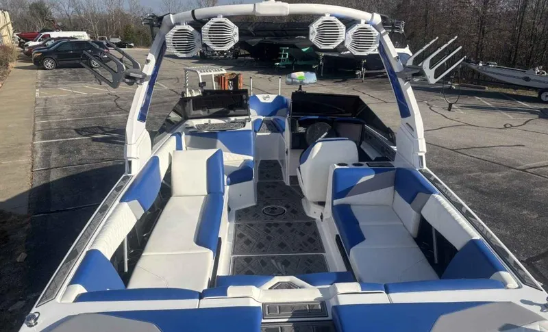 Slide: The Image of 2024 Tigé Z5 boat interior with blue and white seating, advanced audio system, and spacious layout. - 6
