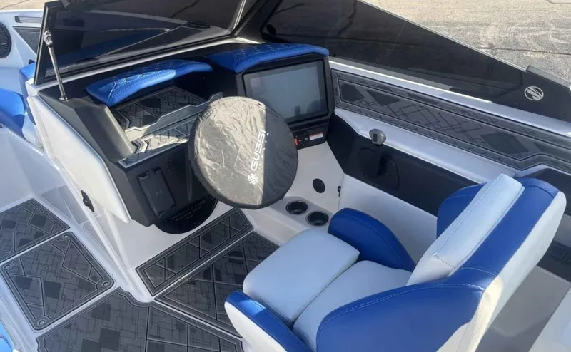 Slide: The Image of 2024 Tigé Z5 boat interior with blue and white seating, modern dashboard, and touchscreen display. - 7