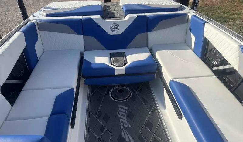 Slide: The Image of 2024 Tigé Z5 boat interior with blue and white seating, modern design. - 9