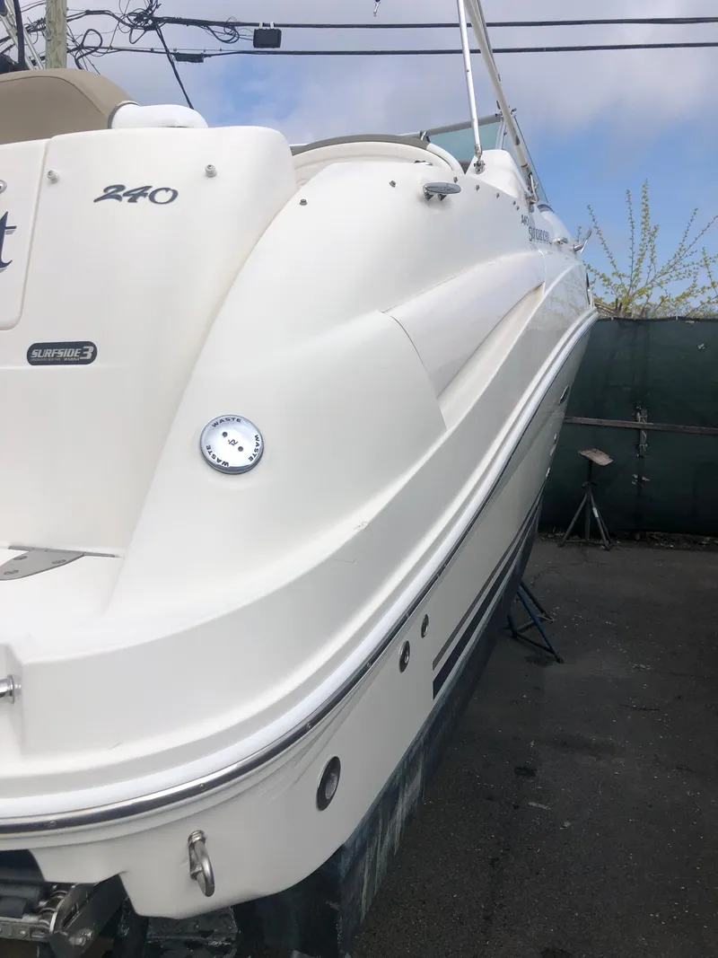 Slide: The Image of 2007 Sea Ray 240 Sundancer boat, white exterior, docked outdoors. - 15